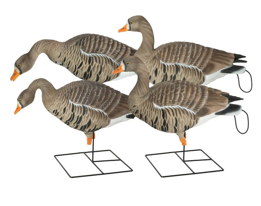 Four goose decoys on stands against a white background