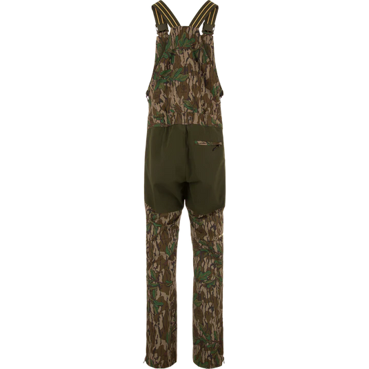 Camouflage hunting bib overalls on a white background